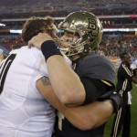 Baylor quarterback Bryce Petty, right, embraces Central Florida offensive linesman Chris Martin after the Fiesta Bowl NCAA college football game, Wednesday, Jan. 1, 2014, in Glendale, Ariz. Central Florida won 52-42. (AP Photo/Ross D. Franklin)