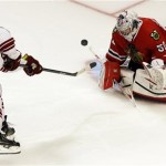  Chicago Blackhawks goalie Corey Crawford, right, blocks a shot by Phoenix Coyotes' Mike Ribeiro in a shootout during an NHL hockey game in Chicago, Thursday, Nov. 14, 2013. The Blackhawks won 5-4. (AP Photo/Nam Y. Huh)