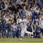 Fans cheer as Los Angeles Dodgers' Juan Uribe rounds the bases after hitting a two-run home run against the Atlanta Braves in the eighth inning of Game 4 in the National League baseball division series Monday, Oct. 7, 2013, in Los Angeles. (AP Photo/Jae C. Hong)