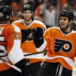 Philadelphia Flyers' Max Talbot, left, who scored, and Zac Rinaldo, right, who got the assist, tap gloves in the second period of an NHL hockey game against the Phoenix Coyotes, Friday, Oct. 11, 2013, in Philadelphia. (AP Photo/Tom Mihalek)