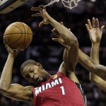 Miami Heat's Chris Bosh (1) is defended by San Antonio Spurs defense during the first half at Game 3 of the NBA Finals basketball series, Tuesday, June 11, 2013, in San Antonio. (AP Photo/Eric Gay)