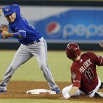 Toronto Blue Jays' Ryan Goins, left, forces Arizona Diamondbacks' A.J. Pollock (11) out at second base in the fifth inning of a baseball game, on Wednesday, Sept. 4, 2013, in Phoenix. Willie Bloomquist was out at first on the double play. (AP Photo/Ross D. Franklin)