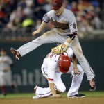Washington Nationals' Adam LaRoche is tagged out by Arizona Diamondbacks second baseman Aaron Hill during the seventh inning of a baseball game at Nationals Park in Washington, Tuesday, June 25, 2013. Ian Desmond was safe at first. The Nationals won 7-5. (AP Photo/Susan Walsh)