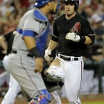 Arizona Diamondbacks' Paul Goldschmidt scores on a base hit by Martin Prado as Texas Rangers catcher Geovany Soto waits for the throw during the first inning of an inter league baseball game, Monday, May 27, 2013, in Phoenix. (AP Photo/Matt York)