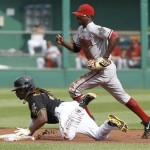 Pittsburgh Pirates' Andrew McCutchen, bottom, steals second base as Arizona Diamondbacks shortstop Didi Gregorius runs past to cover in the first inning of a baseball game Saturday, Aug. 17, 2013, in Pittsburgh. (AP Photo/Keith Srakocic)