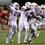 Arizona's Jourdon Grandon (26) celebrates his interception with teammates Tra'Mayne Bondurant (27), Shaquille Richardson (5) and Robert Golden, second from right, and secondary coach Ryan Walters, left, during the fourth quarter of an NCAA college football game against Arizona State Saturday, Nov. 19, 2011, in Tempe, Ariz. Arizona defeated Arizona State 31-27. (AP Photo/Ross D. Franklin)
