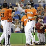 Miami Marlins' Giancarlo Stanton, right, is met at the plate by Christian Yelich (21) after hitting a three-run home run in the first inning during a baseball game against the Arizona Diamondbacks, Sunday, Aug. 17, 2014, in Miami. (AP Photo/Lynne Sladky)