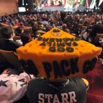Green Bay Packers fan Steve Tate wears cheesehead as he watches the second round of the 2015 NFL Football Draft, Friday, May 1, 2015, in Chicago. (AP Photo/Paul Beaty)