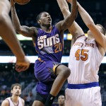 Phoenix Suns' Archie Goodwin (20) drives to the basket past New York Knicks' Cole Aldrich (45) during the second half of an NBA basketball game Sunday, March 15, 2015, in Phoenix. The Suns defeated the Knicks 102-89. (AP Photo/Ralph Freso)
