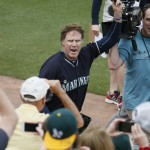 Actor Will Ferrell acknowledges the fans after playing second base for the Seattle Mariners during the second inning of a spring training baseball game against the Oakland Atletics, Thursday, March 12, 2015, in Mesa, Ariz. The comedian plans to play every position while making appearances at five Arizona spring training games on Thursday. (AP Photo/Matt York)
