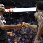 Miami Heat's Chris Bosh, left, greets Miami Heat's Udonis Haslem (40) in the closing moments of their win against the Phoenix Suns during the second half of an NBA basketball game Tuesday, Dec. 9, 2014, in Phoenix. The Heat won 103-97. (AP Photo/Ross D. Franklin)