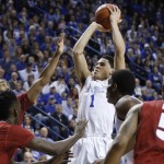 Kentucky's Devin Booker (1) shoots amid Arkansas defenders during the first half of an NCAA college basketball game, Saturday, Feb. 28, 2015, in Lexington, Ky. (AP Photo/James Crisp)