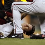 Arizona Diamondbacks' Tuffy Gosewisch holds his leg as he is tended to by teammates after being injured running out a ground out during the sixth inning of a baseball game against the St. Louis Cardinals Wednesday, May 27, 2015, in St. Louis. Gosewisch left the game. (AP Photo/Jeff Roberson)