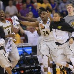 The Wichita State bench reacts after a dunk by teammate Wichita State's Zach Brown (1) against Indiana during the second half of an NCAA tournament college basketball game in the Round of 64 in Omaha, Neb., Friday, March 20, 2015. (AP Photo/Nati Harnik)