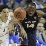 Kentucky guard Devin Booker (1) and Auburn guard Antoine Mason (14) vie for a loose ball during the second half of an NCAA college basketball game in the semifinal round of the Southeastern Conference tournament, Saturday, March 14, 2015, in Nashville, Tenn. (AP Photo/Mark Humphrey)