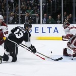 Arizona Coyotes defenseman Klas Dahlbeck, left, and goalie Mike Smith, right, prevent Los Angeles Kings right wing Dustin Brown from scoring during the second period of an NHL hockey game, Monday, March 16, 2015, in Los Angeles. (AP Photo/Danny Moloshok)