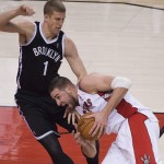 Toronto Raptors forward Jonas Valanciunas, right, drives into Brooklyn Nets forward Mason Plumlee (1) during the first half of Game 2 in an NBA basketball first-round playoff series, Tuesday, April 22, 2014, in Toronto. (AP Photo/The Canadian Press, Nathan Denette)