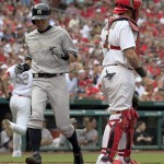  New York Yankees' Ichiro Suzuki, left, scores on a single by Kelly Johnson as St. Louis Cardinals catcher Yadier Molina stands by during the fifth inning of a baseball game Monday, May 26, 2014, in St. Louis. (AP Photo/Jeff Roberson)