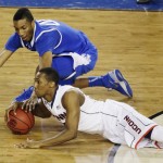 Connecticut guard Lasan Kromah and Kentucky forward Marcus Lee go after a loose ball during the first half of the NCAA Final Four tournament college basketball championship game Monday, April 7, 2014, in Arlington, Texas. (AP Photo/Tony Gutierrez)