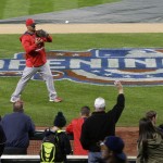 Fans watch as Los Angeles Angels first baseman Albert Pujols warms up before an opening day baseball game against the Seattle Mariners, Monday, April 6, 2015, in Seattle. (AP Photo/Ted S. Warren)