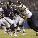 New Orleans Saints outside linebacker Kasim Edebali (91) grabs Chicago Bears quarterback Jay Cutler (6) during the first half of an NFL football game Monday, Dec. 15, 2014, in Chicago. (AP Photo/Nam Y. Huh)
