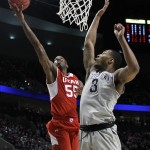 Utah guard Delon Wright, left, shoots against Georgetown forward Mikael Hopkins during the first half of an NCAA college basketball tournament round of 32 game in Portland, Ore., Saturday, March 21, 2015. (AP Photo/Craig Mitchelldyer)