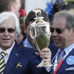 Trainer Bob Baffert and owner of American Pharoah Ahmed Zayat hold up the winning trophy after the 141st running of the Kentucky Derby horse race at Churchill Downs Saturday, May 2, 2015, in Louisville, Ky. (AP Photo/Brynn Anderson)