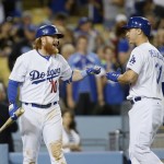 Los Angeles Dodgers Joc Pederson, right, celebrates his solo home run with Justin Turner, left, against the Arizona Diamondbacks during the seventh inning of a baseball game, Saturday, May 2, 2015, in Los Angeles. (AP Photo/Danny Moloshok)