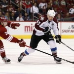 Colorado Avalanche's Cody McLeod (55) tries to keep the puck away from Arizona Coyotes' Oliver Ekman-Larsson (23), of Sweden, during the first period of an NHL hockey game Tuesday, Nov. 25, 2014, in Glendale, Ariz. (AP Photo/Ross D. Franklin)