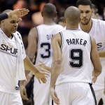 San Antonio Spurs guard Patty Mills, left, celebrates with guard Tony Parker (9) against the Miami Heat during the first half in Game 1 of the NBA basketball finals on Thursday, June 5, 2014, in San Antonio. (AP Photo/Eric Gay)