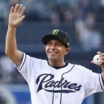 Triple Crown-winning jockey Victor Espinoza waves to the crowd before throwing out the ceremonial first pitch before the baseball game between the Arizona Diamondbacks and the San Diego Padres in a baseball game Friday, June 26, 2015, in San Diego. (AP Photo/Lenny Ignelzi)
