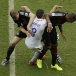 United States' Clint Dempsey (8) gets tangled with Germany's Per Mertesacker, left, and Germany's Jerome Boateng during the group G World Cup soccer match at the Arena Pernambuco in Recife, Brazil, Thursday, June 26, 2014. (AP Photo/Hassan Ammar)
