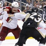 Pittsburgh Penguins' Steve Downie, right, fights Arizona Coyotes' Shane Doan during the second period of an NHL hockey game in Pittsburgh, Saturday, March 28, 2015. (AP Photo/Gene J. Puskar)
