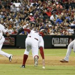Arizona Diamondbacks' Brad Ziegler, middle, is unable to make a play on a ball that was hit off his chest by Detroit Tigers' J.D. Martinez as Diamondbacks' Martin Prado, left, looks on and Detroit Tigers' Miguel Cabrera (24) starts his slide into third base during the eighth inning of a baseball game on Tuesday, July 22, 2014, in Phoenix. (AP Photo)