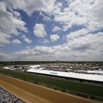 In this photo made with a fish eye lens, People line the infield and grand stand before the 139th Preakness Stakes horse race at Pimlico Race Course, Saturday, May 17, 2014, in Baltimore. (AP Photo/Mike Stewart)
