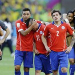 Chilean players walk off the pitch after a penalty shootout following regulation time during the World Cup round of 16 soccer match between Brazil and Chile at the Mineirao Stadium in Belo Horizonte, Brazil, Saturday, June 28, 2014. Brazil won 3-2 on penalties after a 1-1 tie. (AP Photo/Ricardo Mazalan)