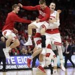 Wisconsin forward Sam Dekker, right, celebrates with teammates after beating Arizona 85-78 in a college basketball regional final in the NCAA Tournament, Saturday, March 28, 2015, in Los Angeles. Wisconsin will play in the Final Four in Indianapolis. (AP Photo/Jae C. Hong)