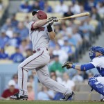 Arizona Diamondbacks' Paul Goldschmidt hits a home run in front of Los Angeles Dodgers catcher Yasmani Grandal to score Ender Inciarte during the first inning of a baseball game, Saturday, May 2, 2015, in Los Angeles. (AP Photo/Danny Moloshok)