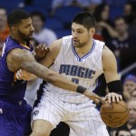 Orlando Magic's Nikola Vucevic, right, makes a move to get around Phoenix Suns' Markieff Morris, left, during the first half of an NBA basketball game, Wednesday, March 4, 2015, in Orlando, Fla. (AP Photo/John Raoux)