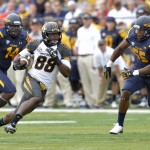 Missouri wide receiver Jimmie Hunt (88) runs between Toledo linebacker Tre James (14) and defensive end Ray Bush (55) in the first half of an NCAA college football game in Toledo, Ohio, Saturday, Sept. 6, 2014. (AP Photo/David Richard)