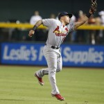 St. Louis Cardinals' Kolten Wong jumps to make a catch on a line drive hit by Arizona Diamondbacks' Trevor Cahill during the fourth inning of a baseball game Friday, Sept. 26, 2014, in Phoenix. (AP Photo/Ross D. Franklin)