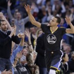 Golden State Warriors' Stephen Curry (30) celebrates after scoring against the Phoenix Suns during the first half of an NBA basketball game Saturday, Jan. 31, 2015, in Oakland, Calif. (AP Photo/Marcio Jose Sanchez)