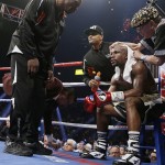 Floyd Mayweather Jr., right, sits in his corner with his father, head trainer Floyd Mayweather Sr., left, during his welterweight title fight against Manny Pacquiao on Saturday, May 2, 2015 in Las Vegas. (AP Photo/Isaac Brekken)