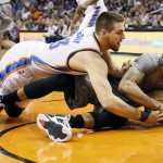 Phoenix Suns Marcus Morris tries to call time out as Oklahoma City Thunder Mitch McGary battles for the ball during the first half of an NBA basketball game, Thursday, Feb. 26, 2015, in Phoenix. (AP Photo/Matt York)
