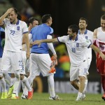 Greek players celebrate their 2-1 win after the group C World Cup soccer match between Greece and Ivory Coast at the Arena Castelao in Fortaleza, Brazil, Tuesday, June 24, 2014. (AP Photo/Natacha Pisarenko)
