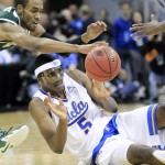UCLA forward Kevon Looney passes off the ball while UAB guard Robert Brown tries to intercept it during the second half of an NCAA tournament third round college basketball game in Louisville, Ky., Saturday, March 21, 2015. UCLA won the game 92-75. (AP Photo/David Stephenson)