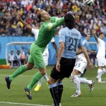 England's goalkeeper Joe Hart clears the ball in front of Uruguay's Edinson Cavani during the group D World Cup soccer match between Uruguay and England at the Itaquerao Stadium in Sao Paulo, Brazil, Thursday, June 19, 2014. (AP Photo/Felipe Dana)