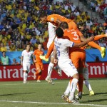 Netherlands' Leroy Fer, top, scores the opening goal during the group B World Cup soccer match between the Netherlands and Chile at the Itaquerao Stadium in Sao Paulo, Brazil, Monday, June 23, 2014. (AP Photo/Frank Augstein)