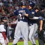 Milwaukee Brewers' Ryan Braun, right, embraces Carlos Gomez (27) after hitting a home run during the sixth inning against the Arizona Diamondbacks in a baseball game Friday, July 24, 2015, in Phoenix. (Isaac Hale/The Arizona Republic via AP
