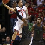 Arizona's Gabe York (1) fouls Oregon's Jalil Abdul-Bassit during the first half of an NCAA college basketball game in the championship of the Pac-12 conference tournament Saturday, March 14, 2015, in Las Vegas. (AP Photo/John Locher)